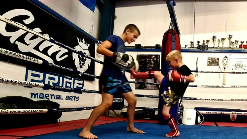 Kids Muay Thai pad work in the ring at Pride Gym Sheffield