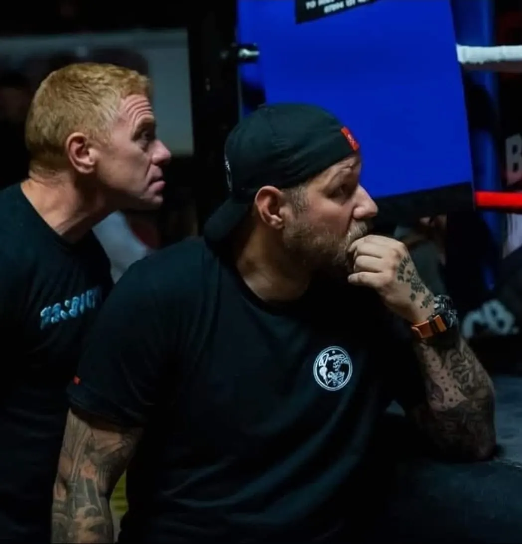 Pride Gym coaches watching intently from the corner during a fight